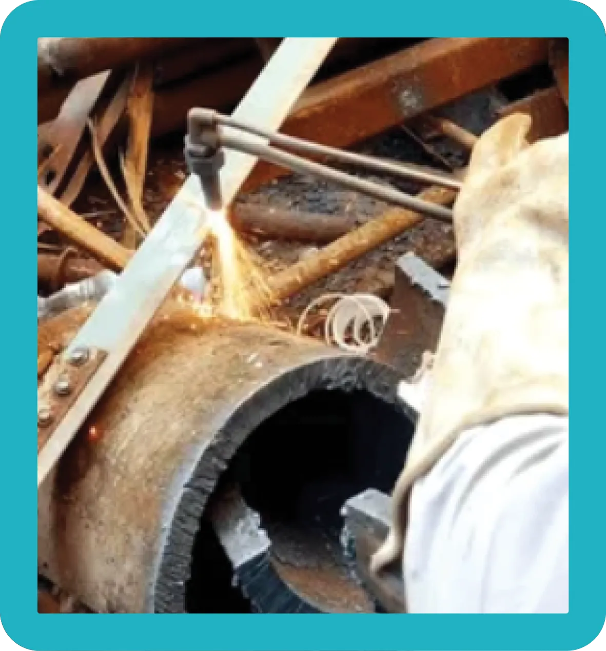 HMS Oxy A man using a tool on a large piece of HMS Oxy