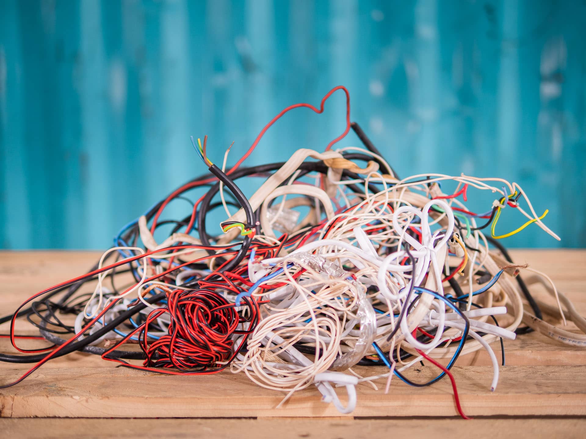 A pile of TPS scrap cable on a wooden table