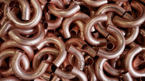 Pile of bent copper pipes.