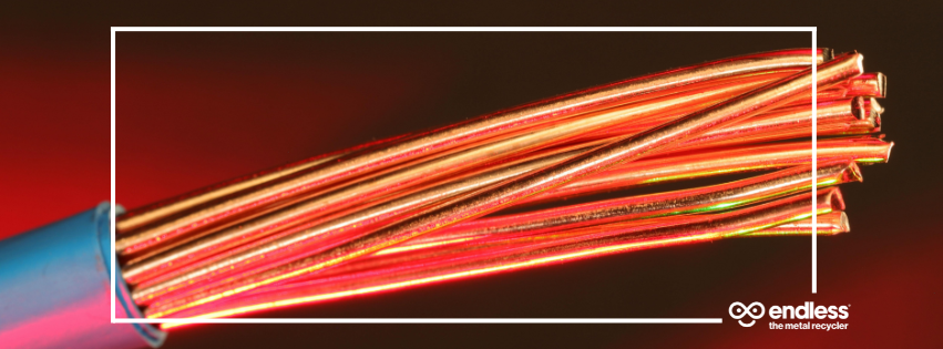 A close up view of copper wire emerging from PVC