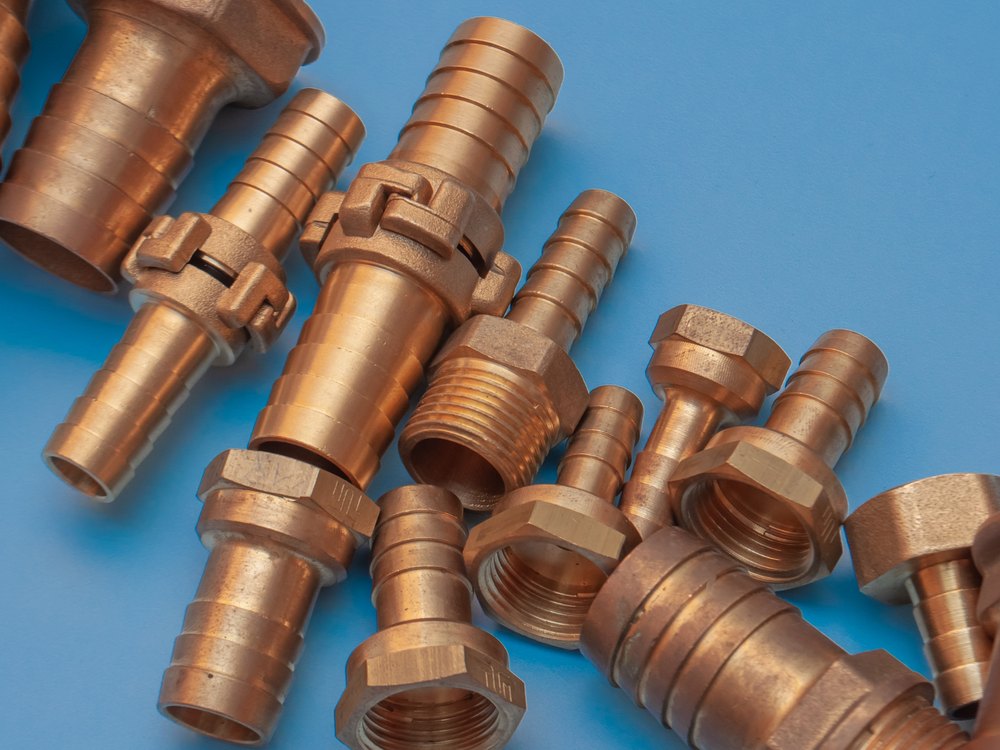 Gunmetal pipe fittings on blue background